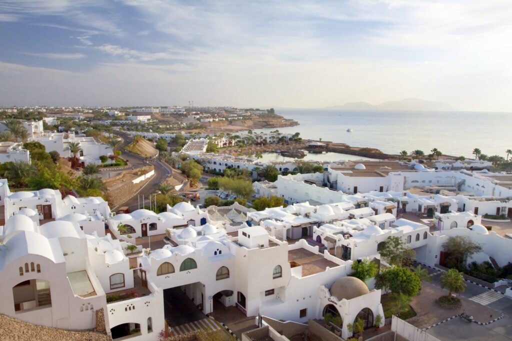 Panoramic view of white buildings along the coastline beside the blue sea, Sharm el Sheikh