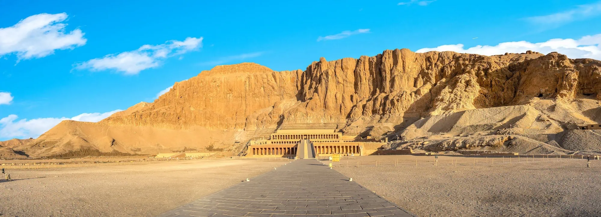 Panoramic view of Queen Hatshepsut's mortuary temple at Deir el-Bahari with terraced limestone architecture