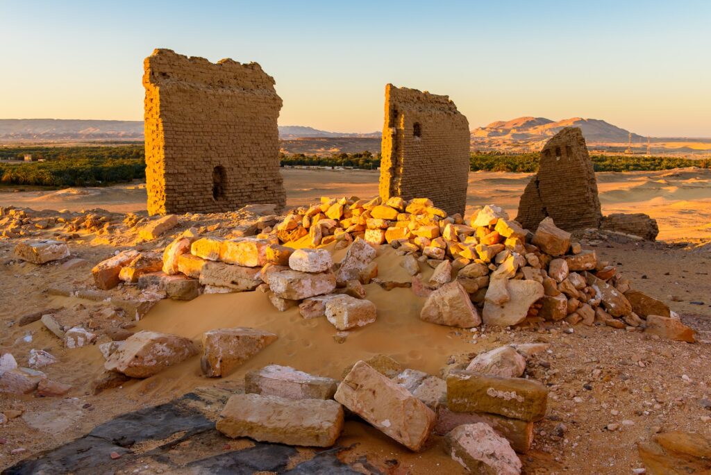 Stone walls and relief details of the Nadora Temple rising above the surrounding desert landscape, Nadora Temple, Kharga
