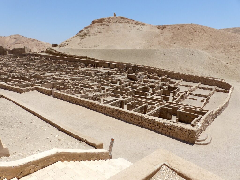 Stone house foundations and low wall remains from the ancient settlement at Deir el-Medina, Luxor