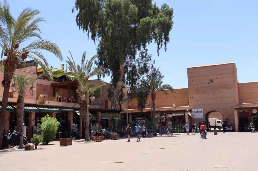 Place des Ferblantiers square with open plaza, surrounding buildings, and market stalls, Marrakesh