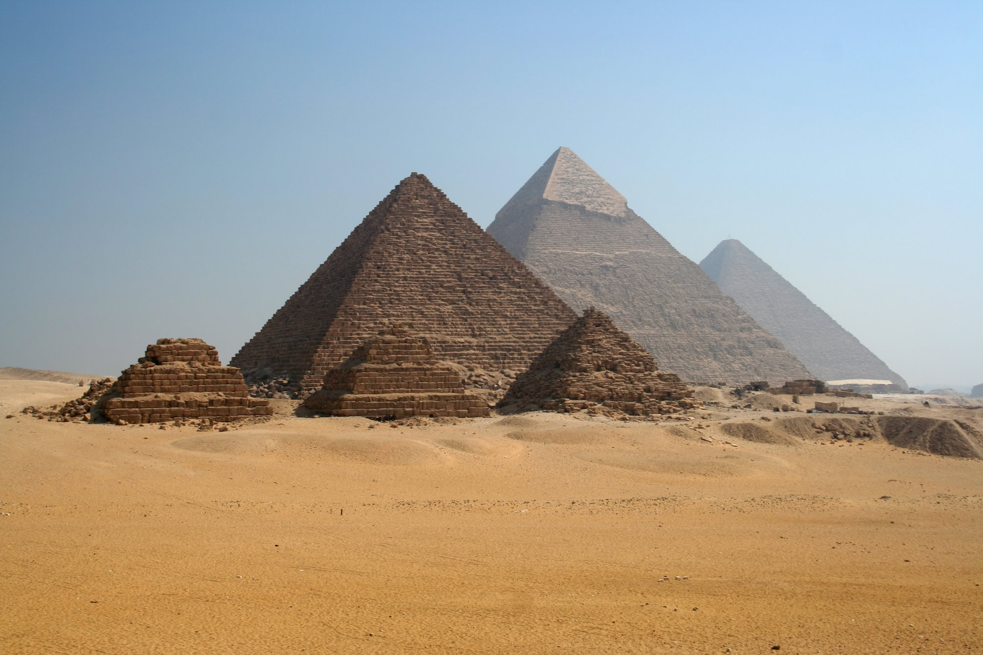 The Great Pyramids of Giza rising from desert sands on the Giza plateau in Egypt