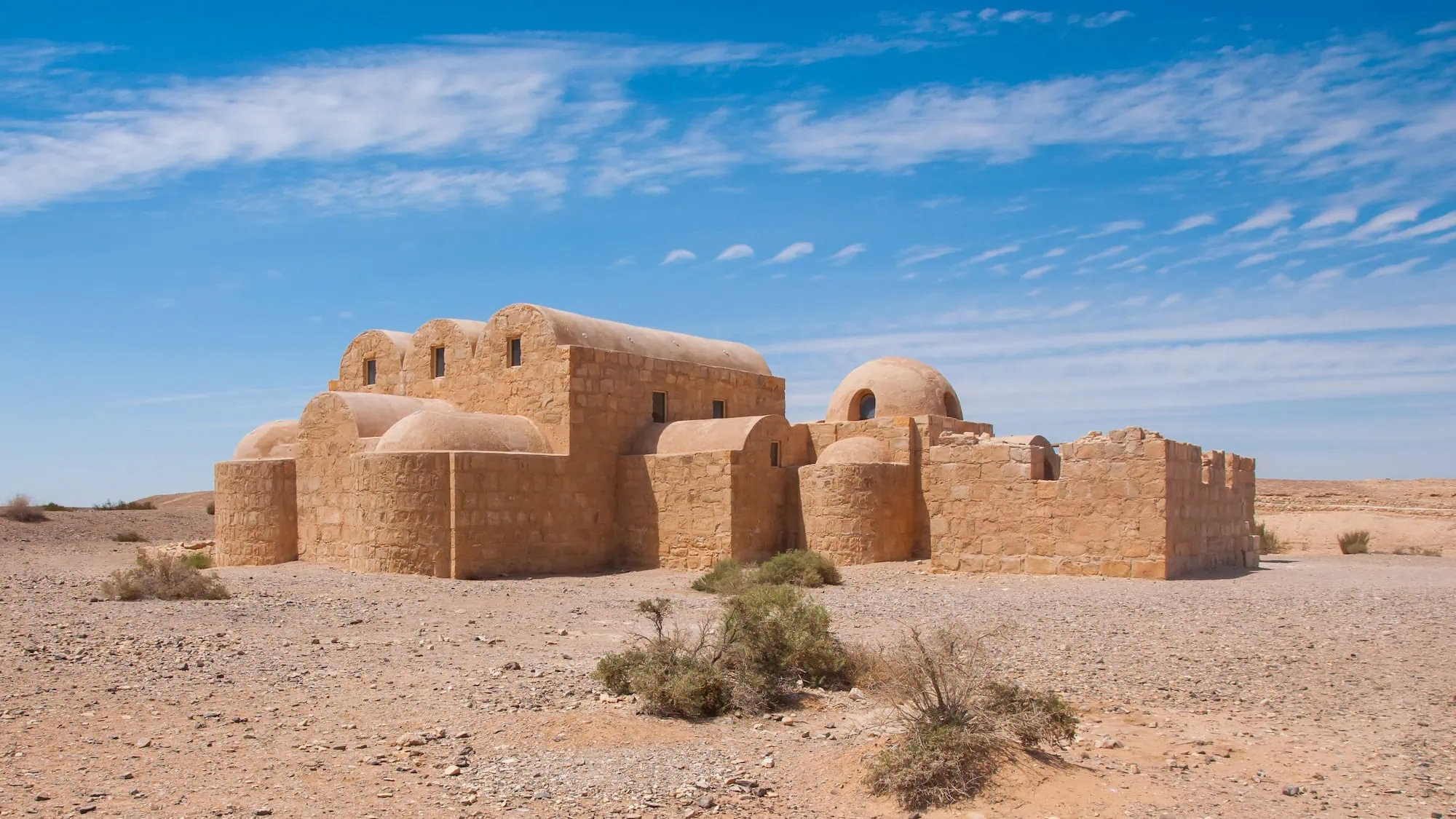 Qasr Amra desert palace with characteristic domed structures and stone walls in Jordan