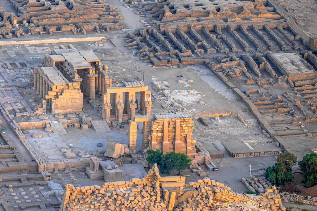 Aerial view of stone ruins and column remains of the Ramesseum set within the desert landscape, Luxor