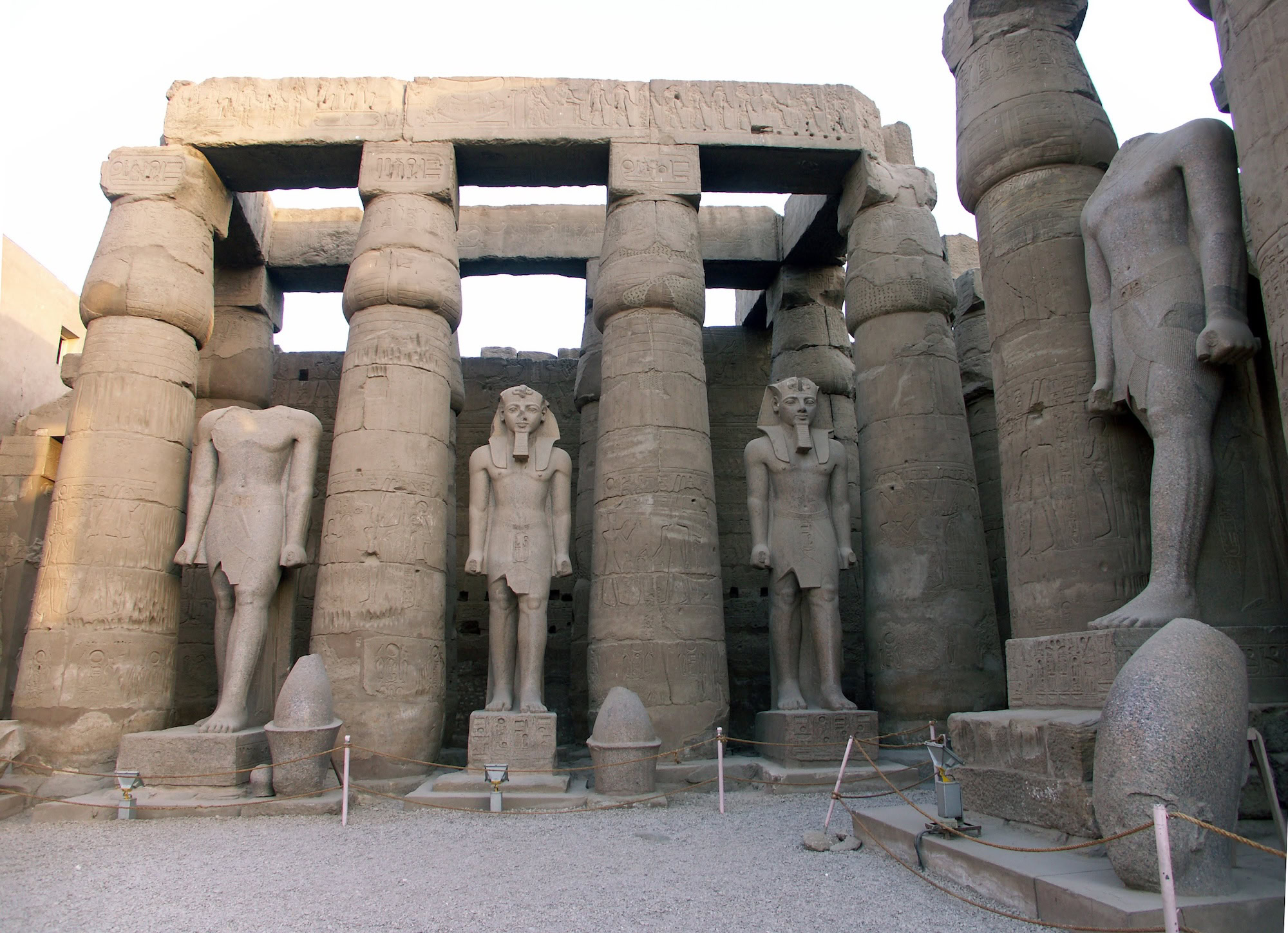 Ancient Luxor Temple with towering stone columns, pharaoh statues, and hieroglyphic carvings