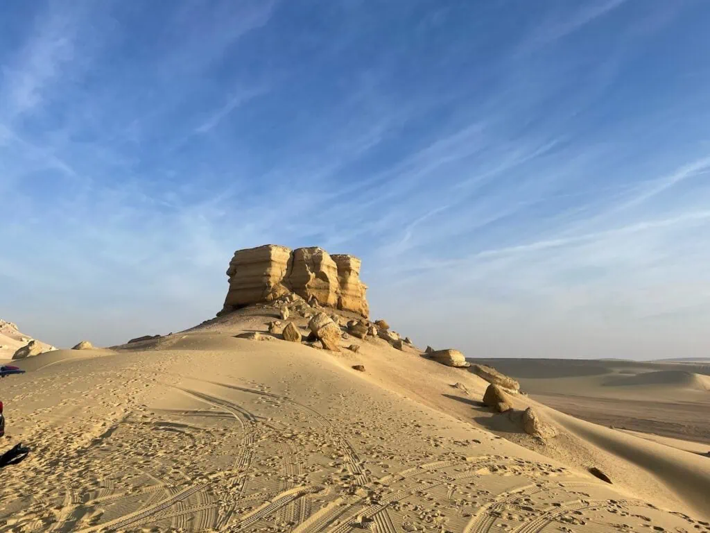 Rock formation rising from the desert landscape near Wadi El Rayan, Fayoum