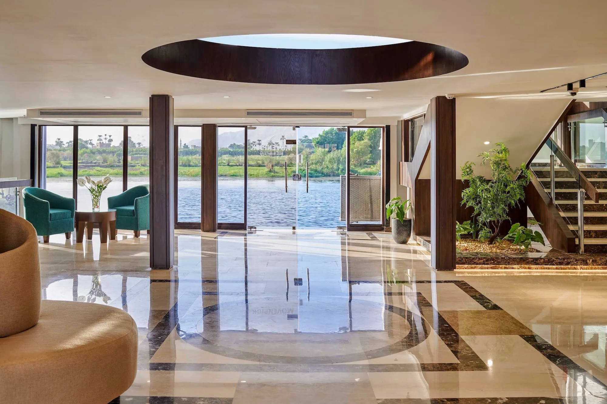 Luxurious Nile cruise ship lobby with elegant seating and river views