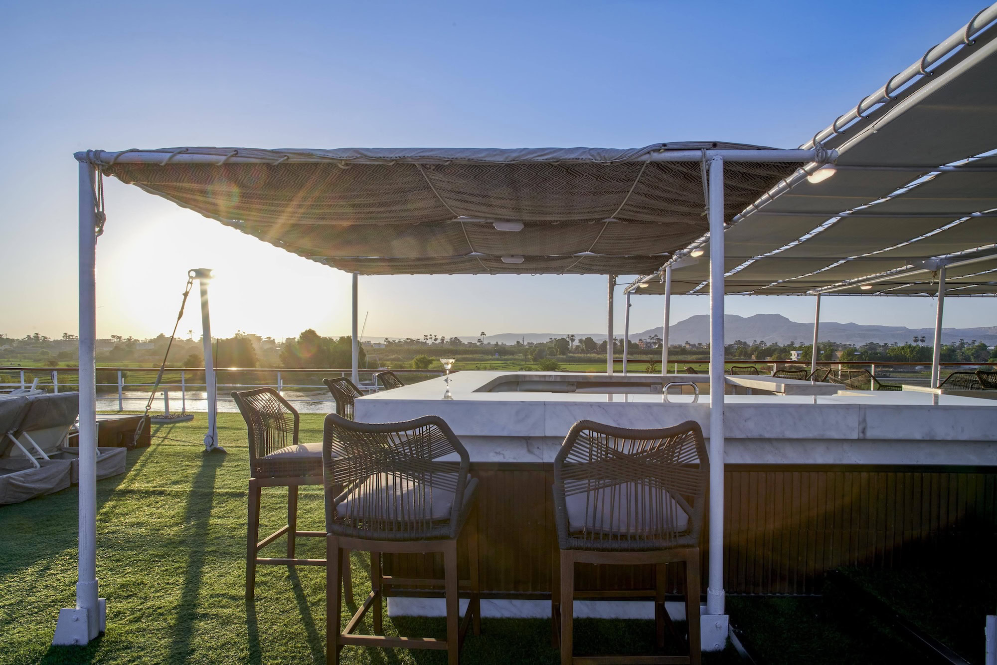 Nile cruise ship deck with outdoor seating and river views
