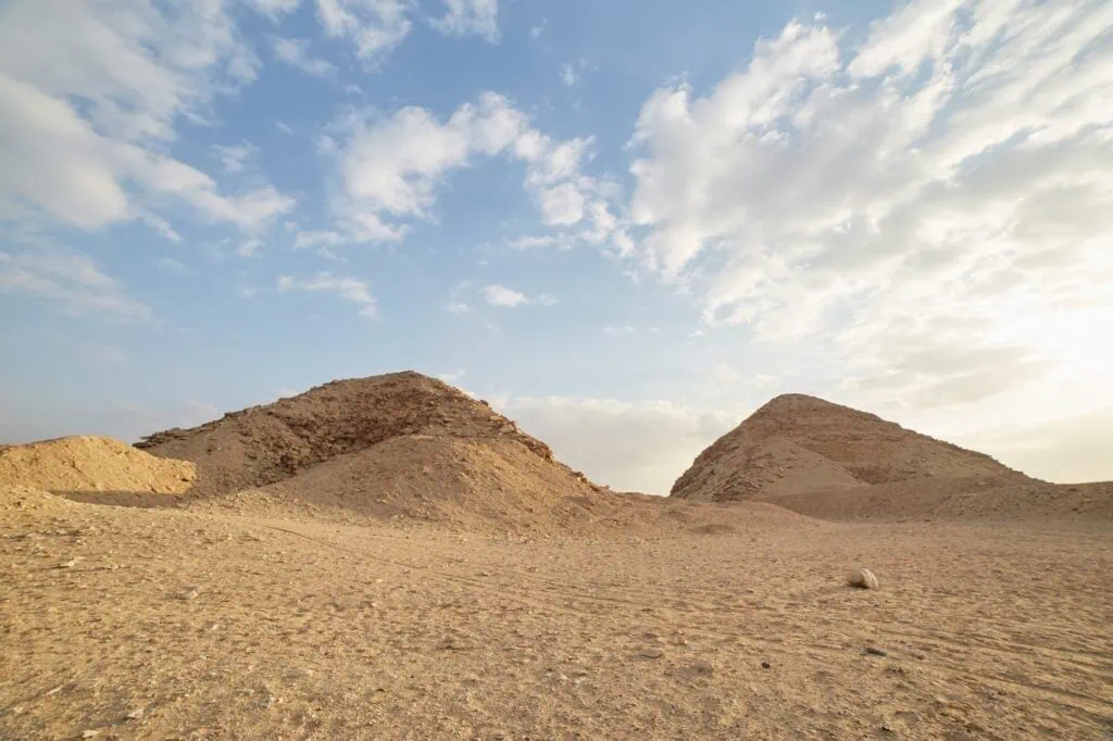 Ruined pyramids rising from the desert landscape at the Abusir Pyramids Complex, Giza