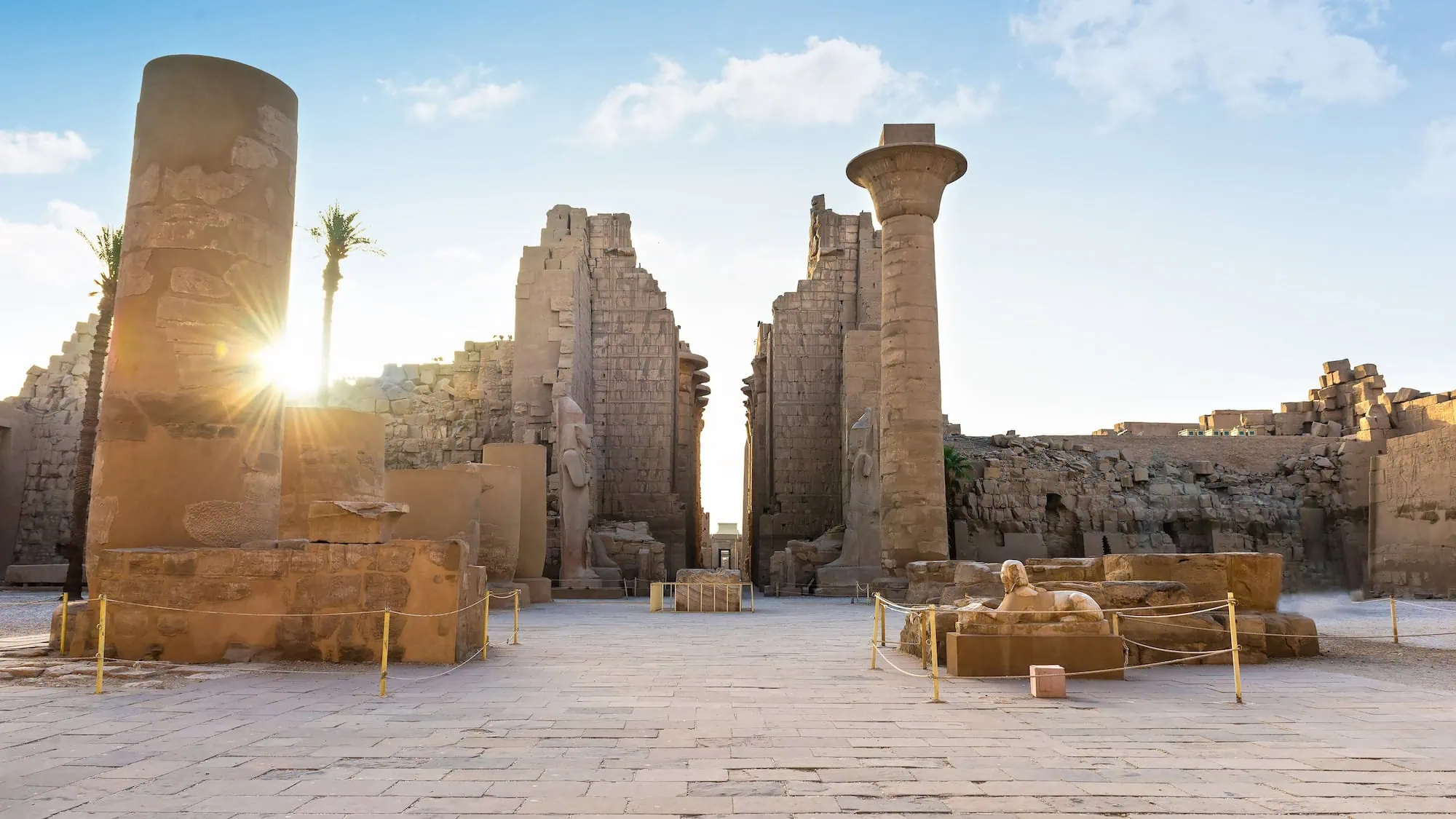 Tall stone columns carved with hieroglyphs within the temple complex, Karnak Temple, Luxor