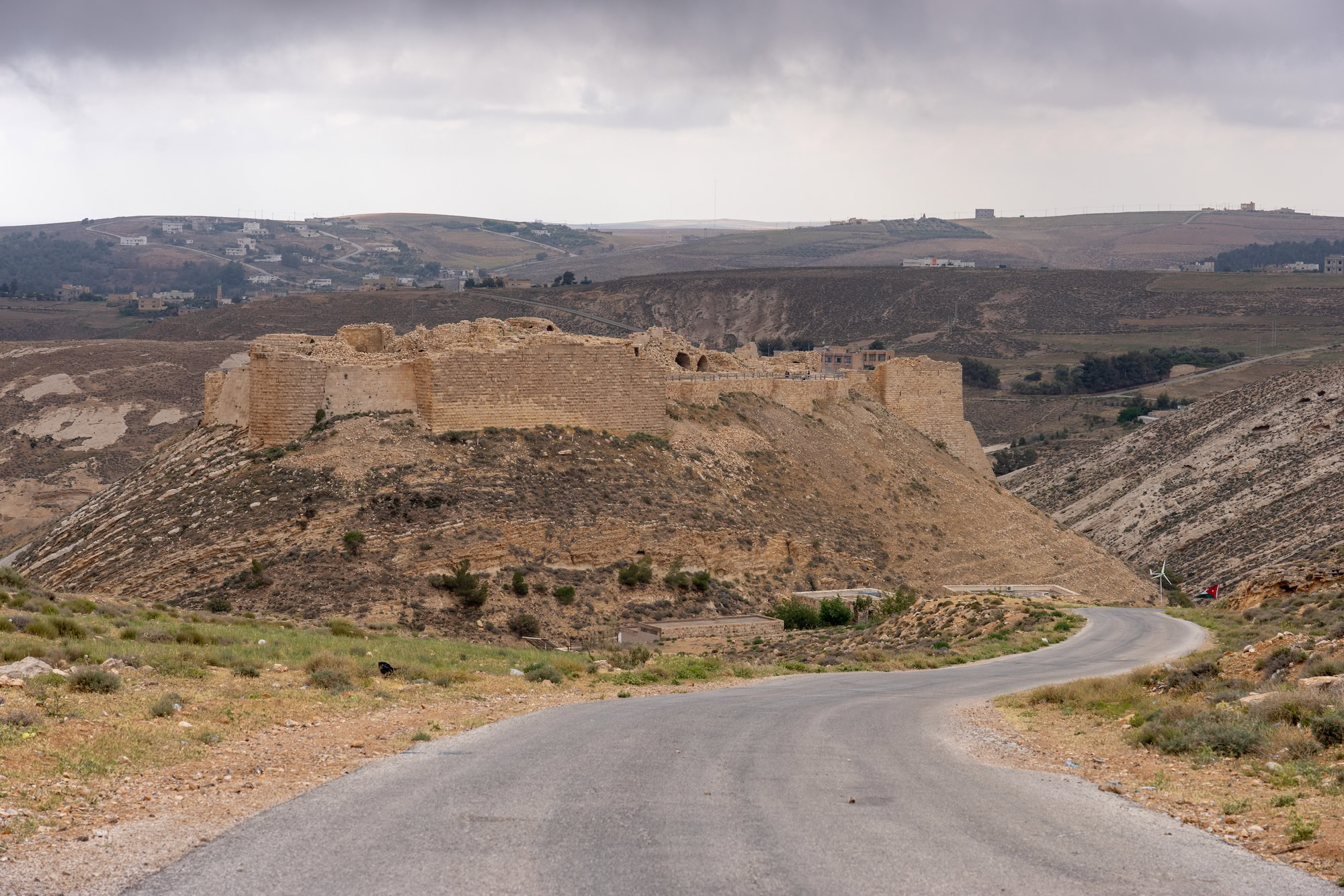 Ancient Middle Eastern fortress ruins in desert landscape showing historical military fortification