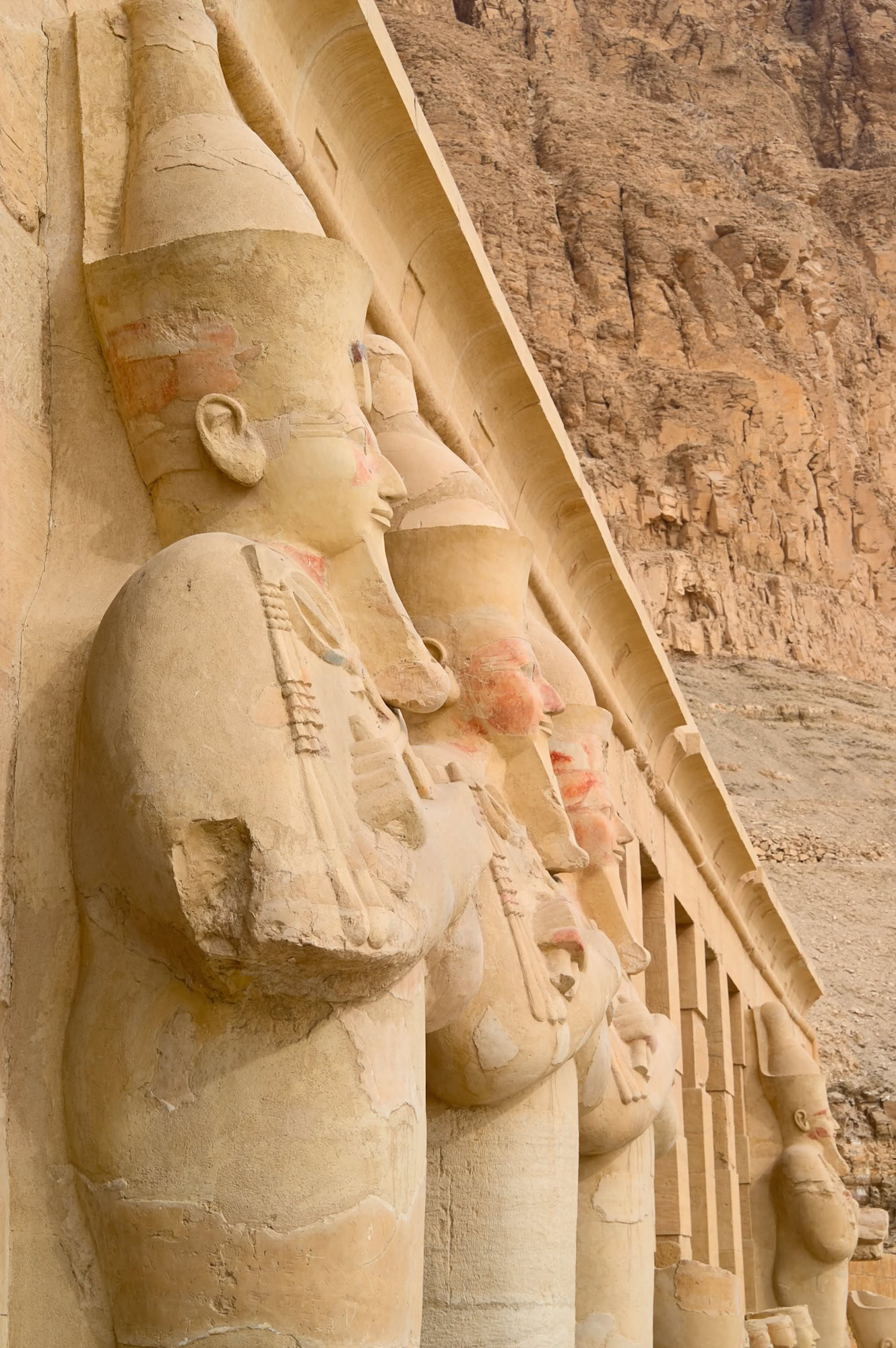 Ancient pharaoh statues and columns at the mortuary Temple of Hatshepsut in Egypt