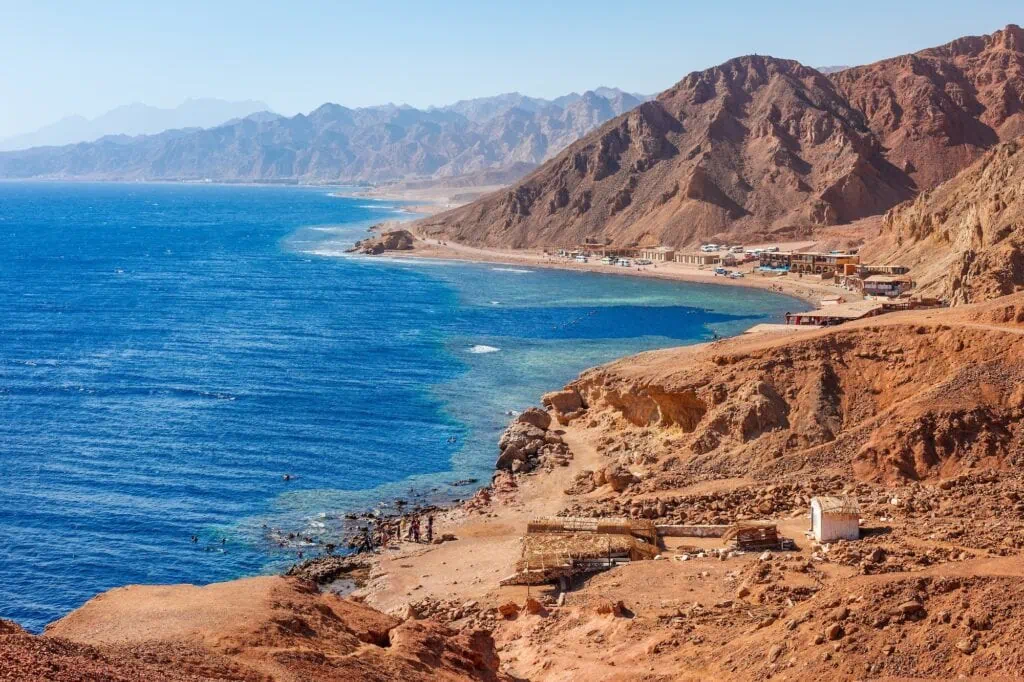 Sea coast near the Blue Hole dive site with clear Red Sea waters and rocky shoreline, Dahab