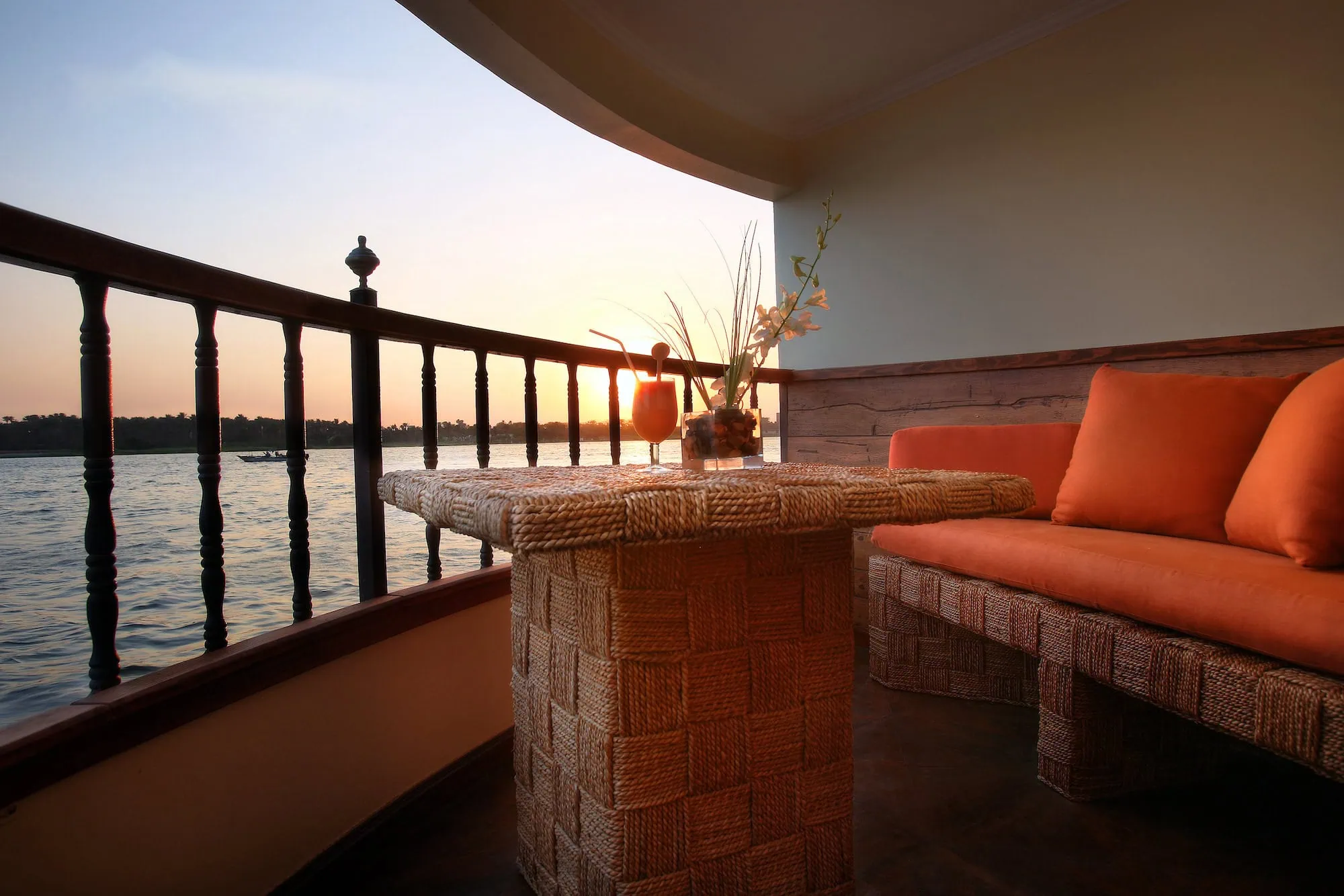 Luxury balcony suite on Nile River cruise ship at sunset showing panoramic river views