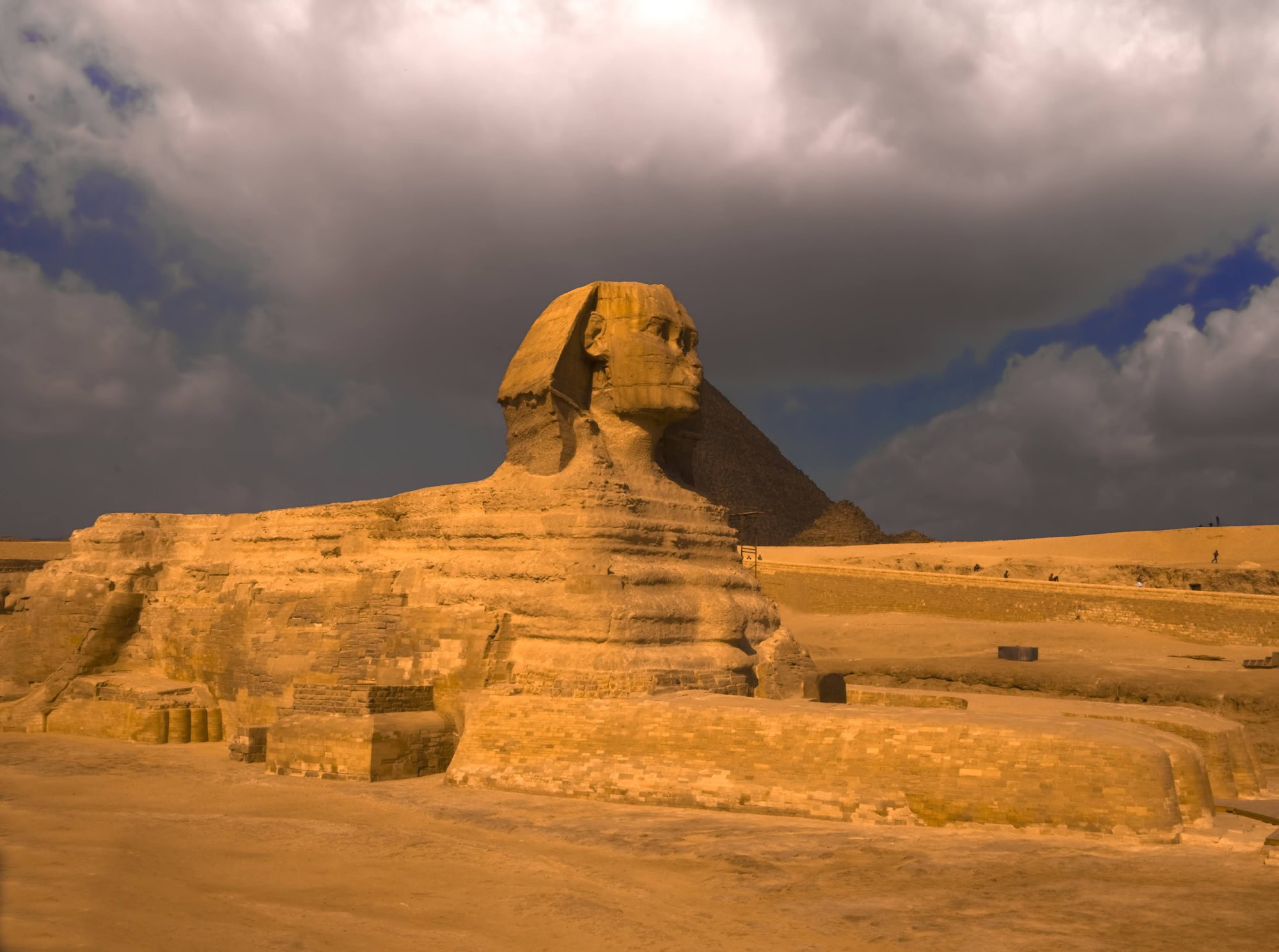 The Great Sphinx of Giza with a pyramid visible in the background