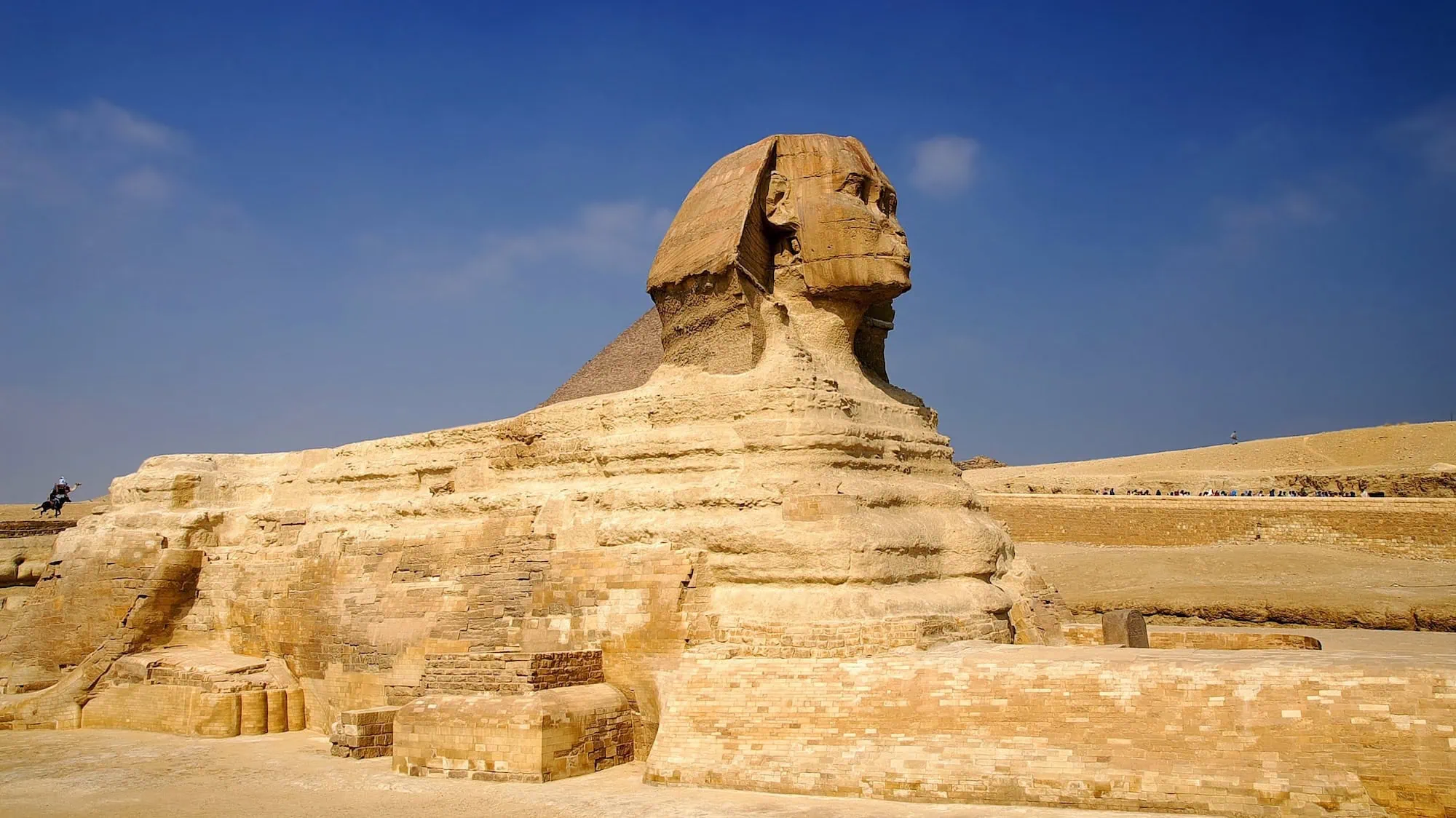 Ancient limestone Sphinx statue showing carved human head on lion body at Giza