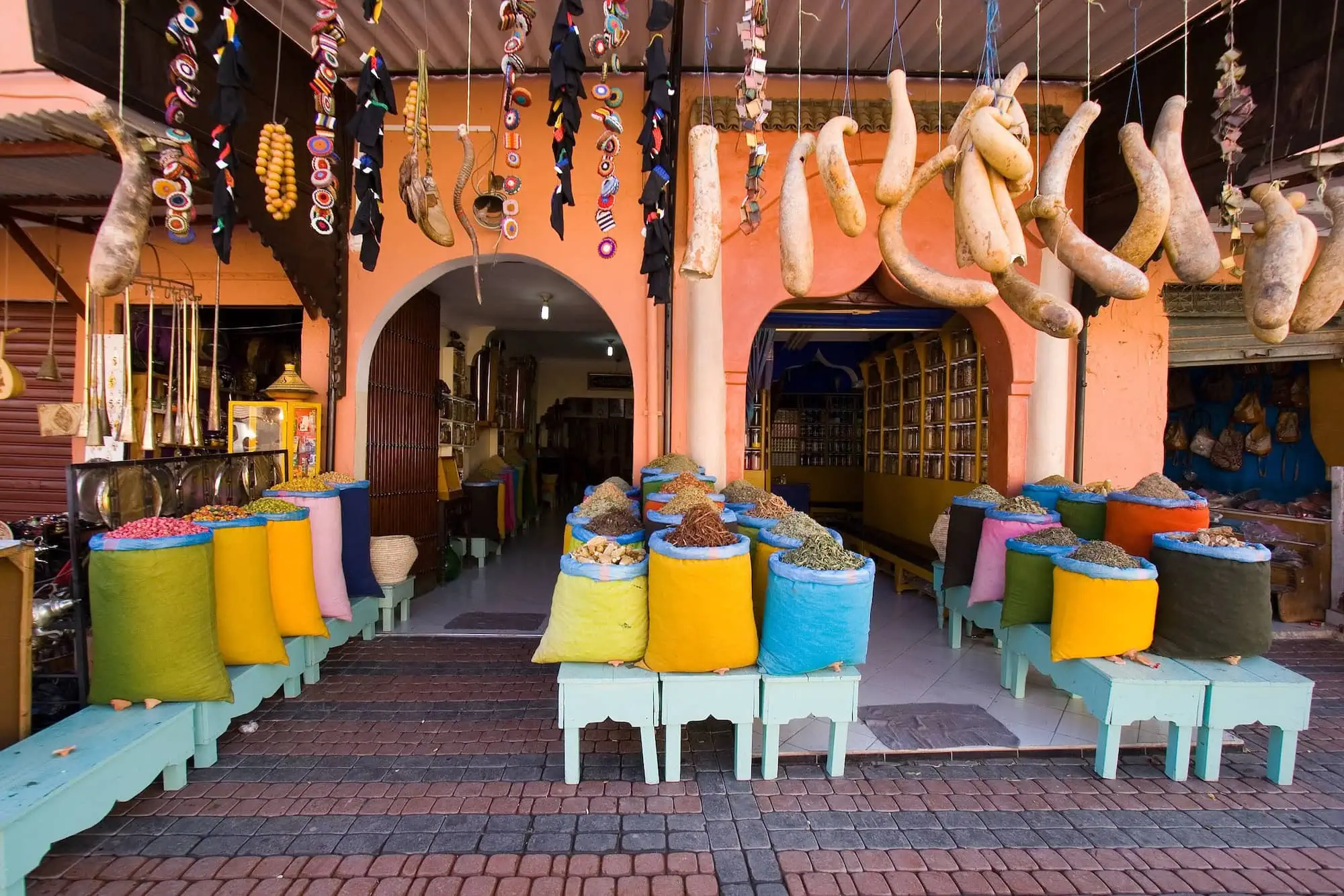 Traditional spice shop in Marrakech souk displaying colorful spices and metalwork crafts