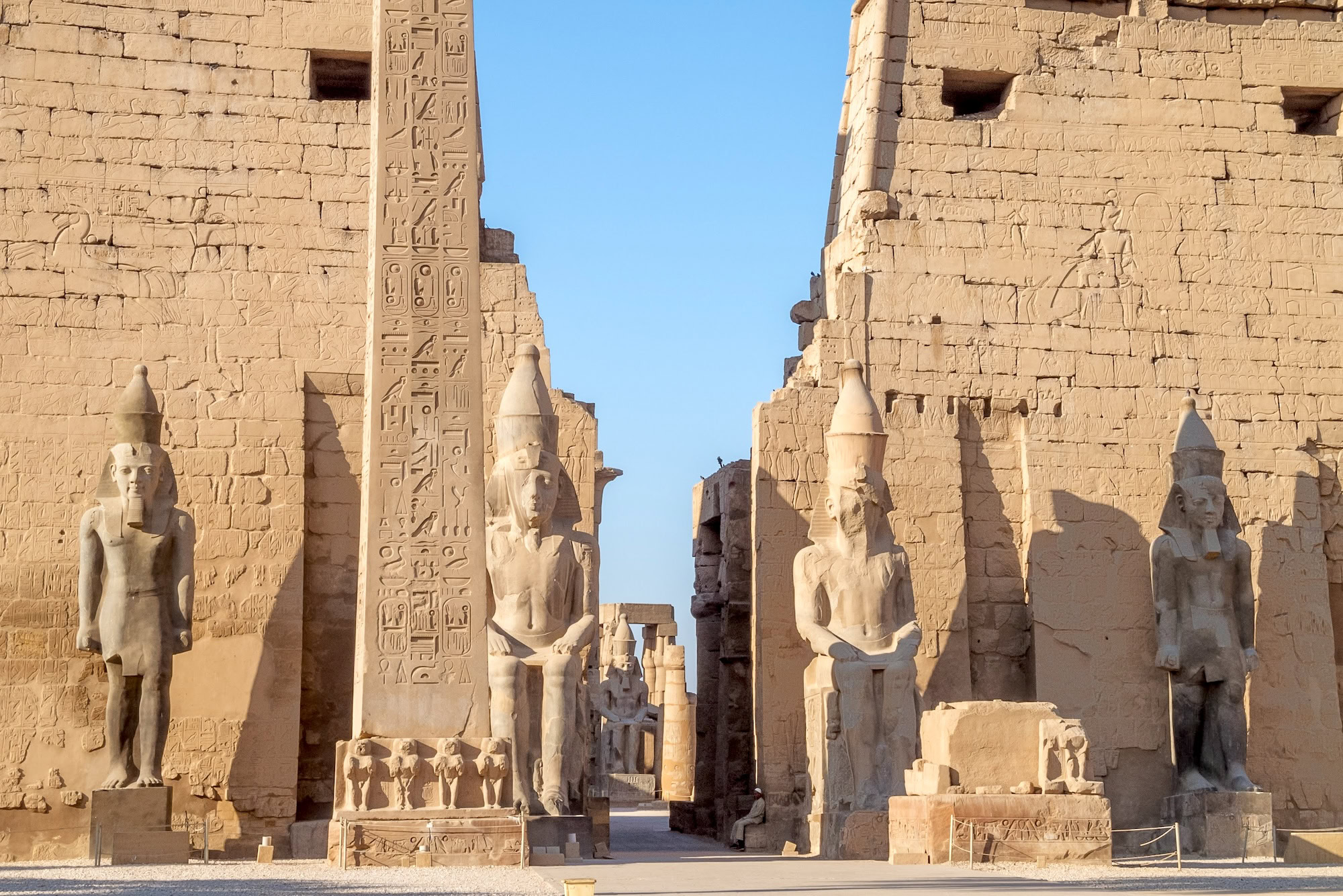 Ancient Egyptian pharaoh statues and hieroglyphs at Luxor Temple