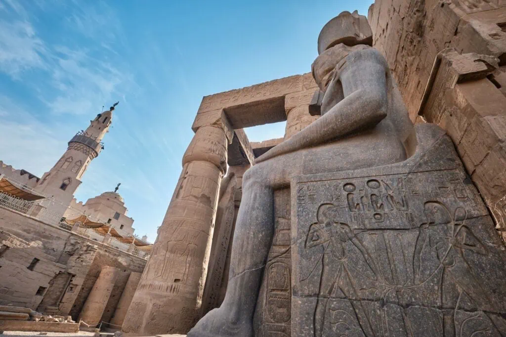 Colossal statue of Ramesses II standing near the Abu Haggag Mosque within the Luxor Temple complex, Luxor