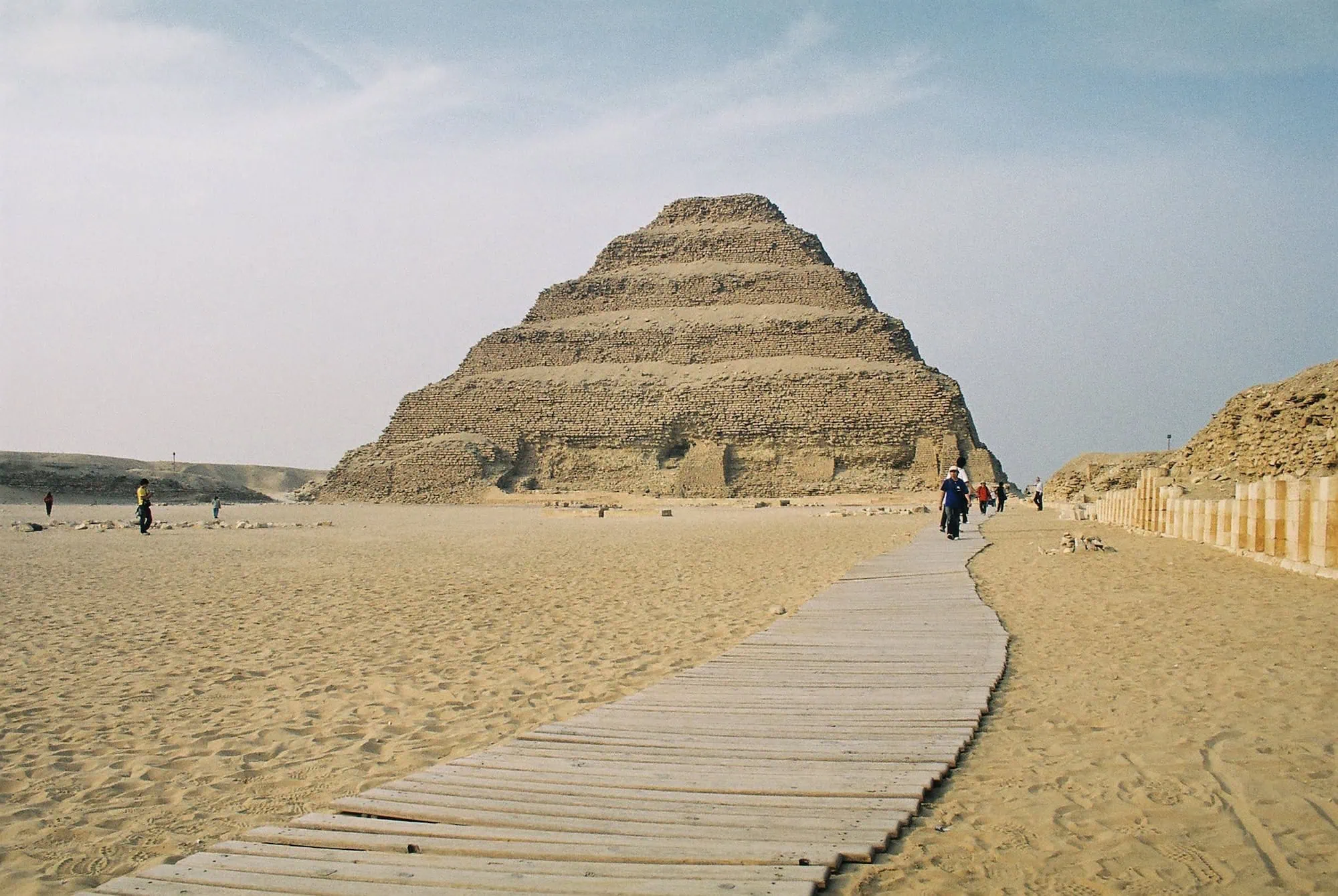 The ancient Step Pyramid of Djoser at Saqqara necropolis with tourists and wooden walkway