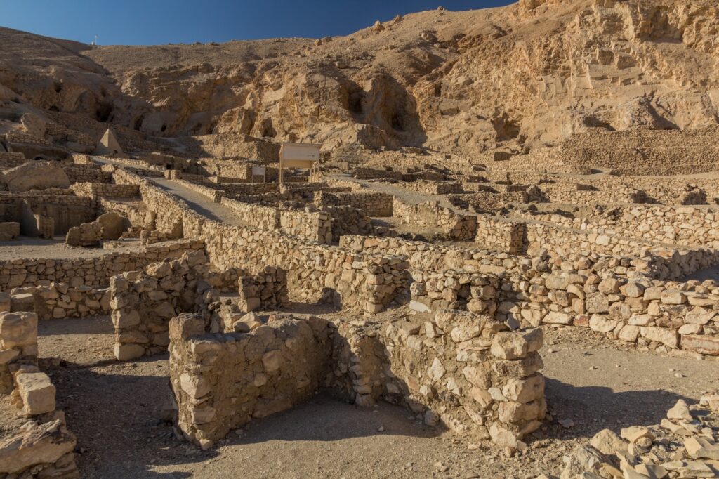 Stone house remains and narrow streets of the ancient workmen’s village at Deir el-Medina, Luxor