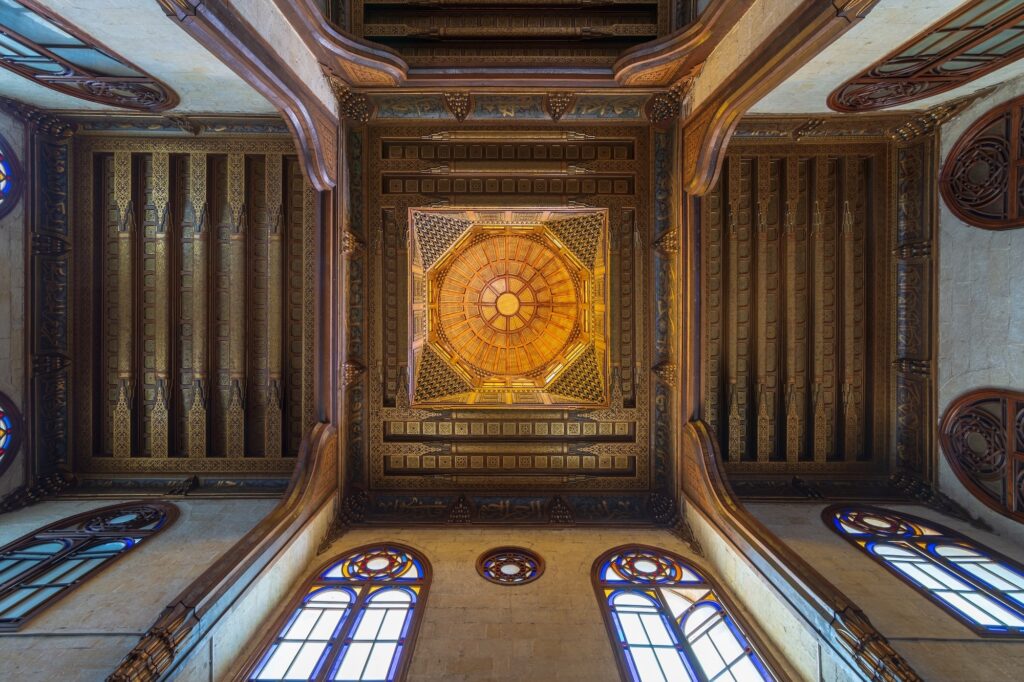Wooden decorated dome beneath an ornate floral-patterned ceiling inside the Sultan al-Ghuri Mausoleum