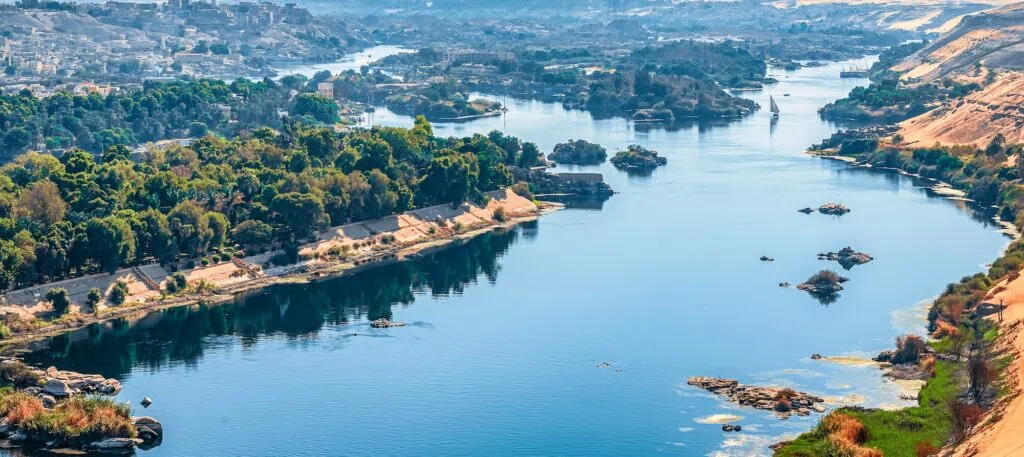 Sunset over the Nile River with sandy desert shores along the riverbank, Aswan