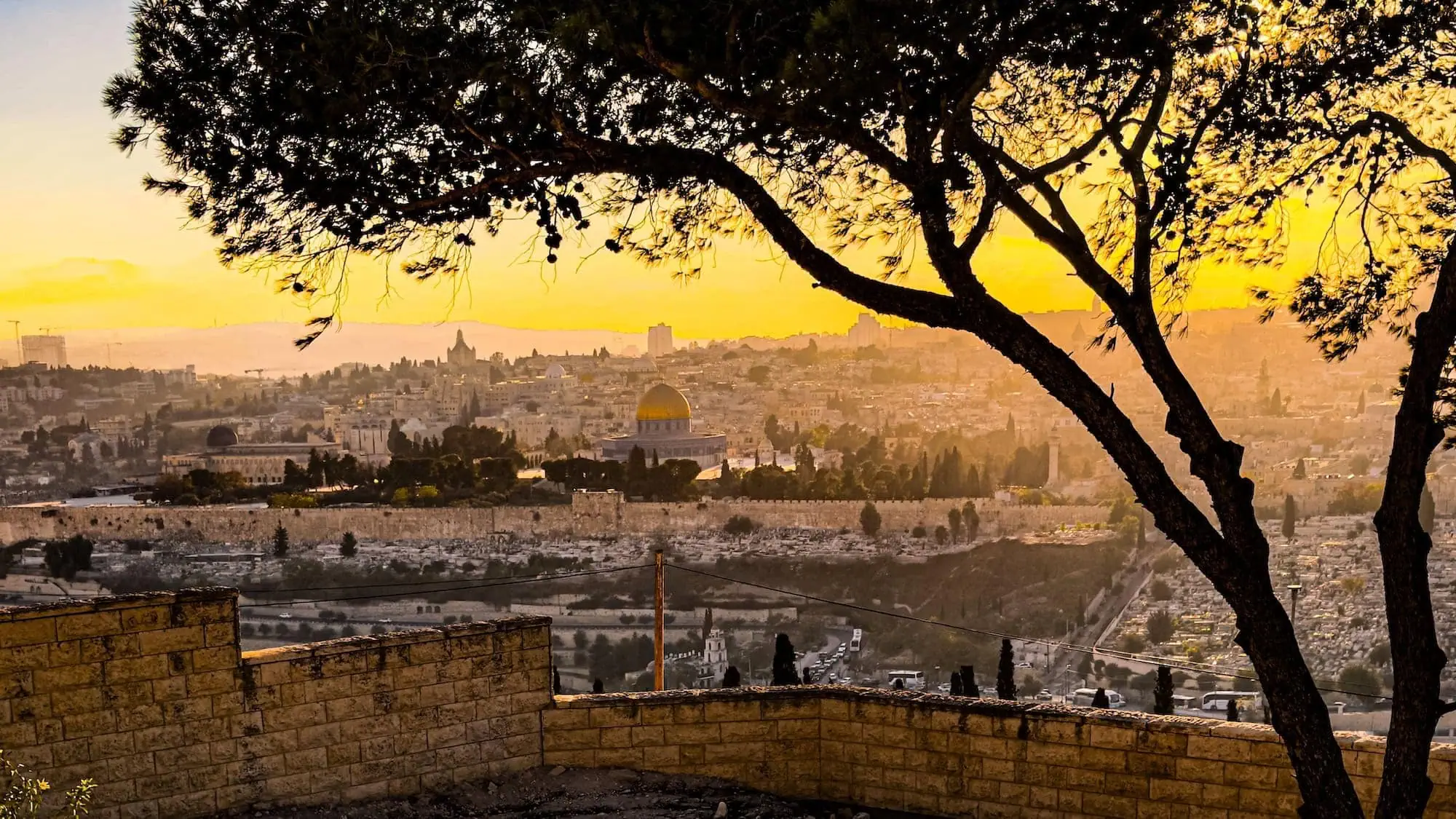 Sunset view over Jerusalem's Old City showing the golden Dome of the Rock