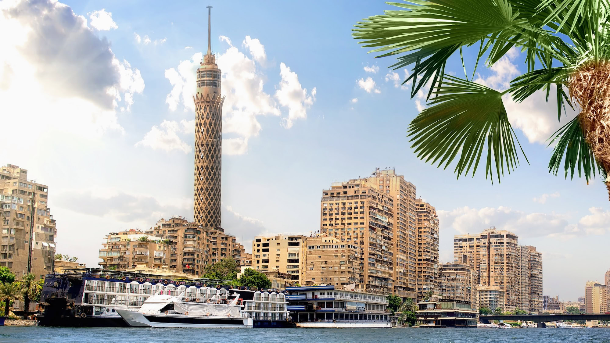 Cairo Tower overlooking the Nile River with boats and city skyline