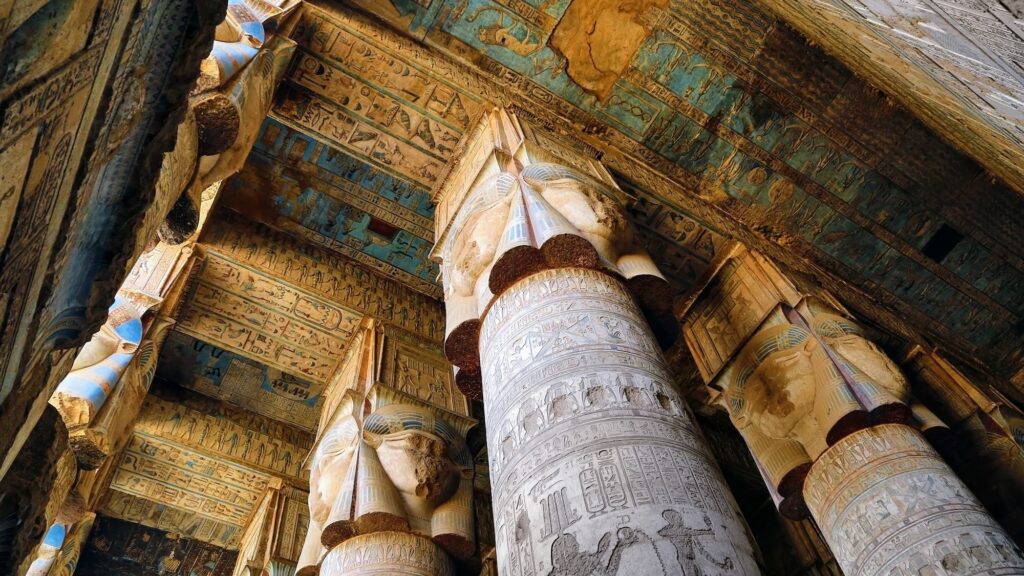 Painted and carved columns inside the hypostyle hall at Dendera Temple