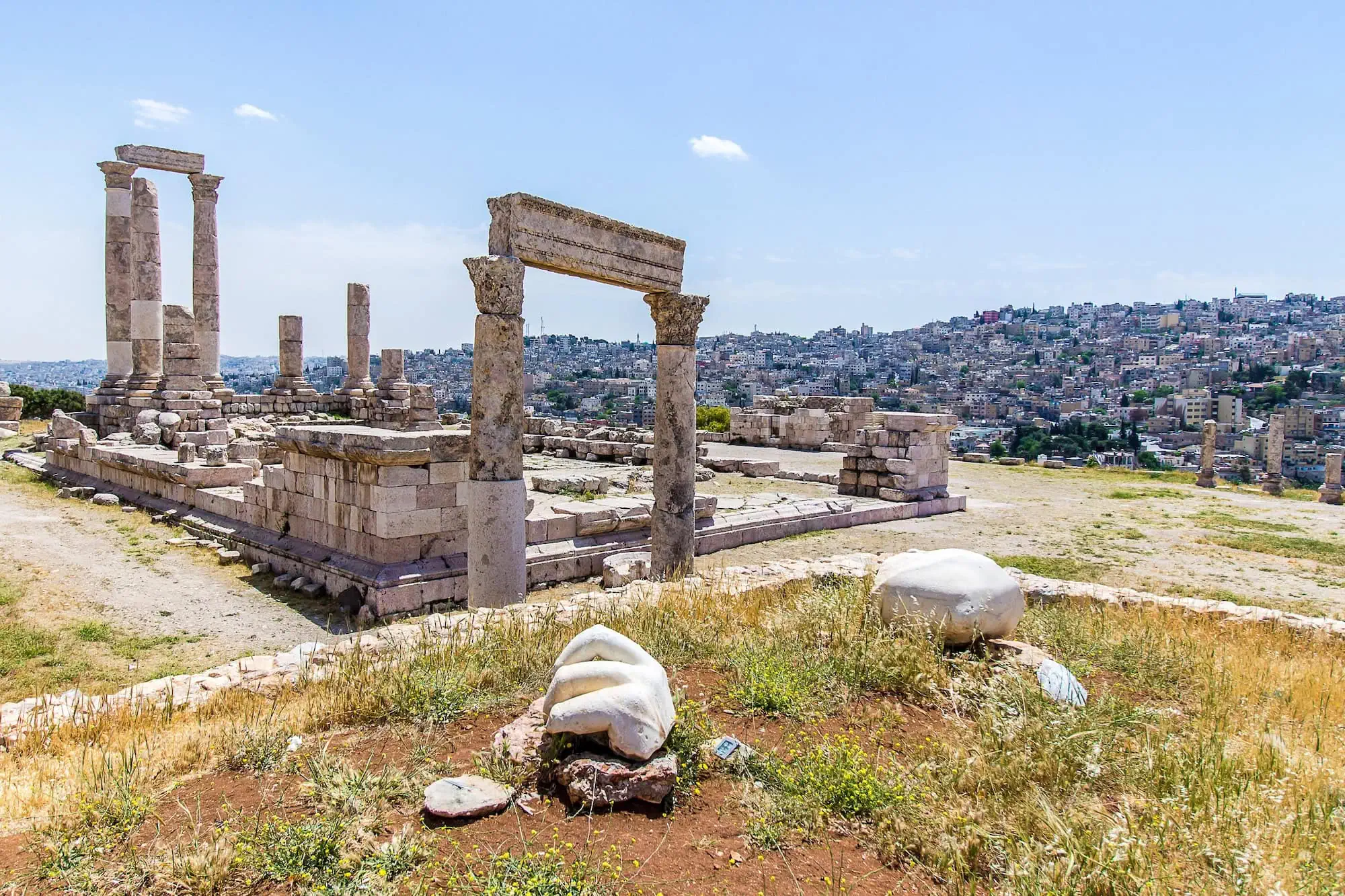 Ancient Temple of Hercules ruins with stone columns and iconic hand sculpture at Amman Citadel