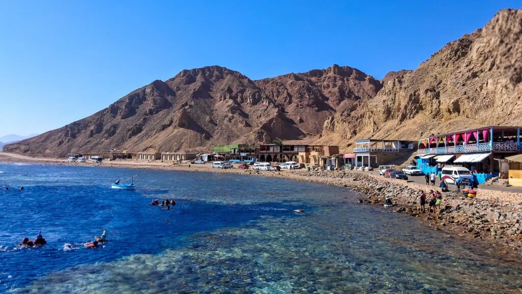 Blue Hole dive site with extensive coral reef and surrounding mountain landscape, Dahab