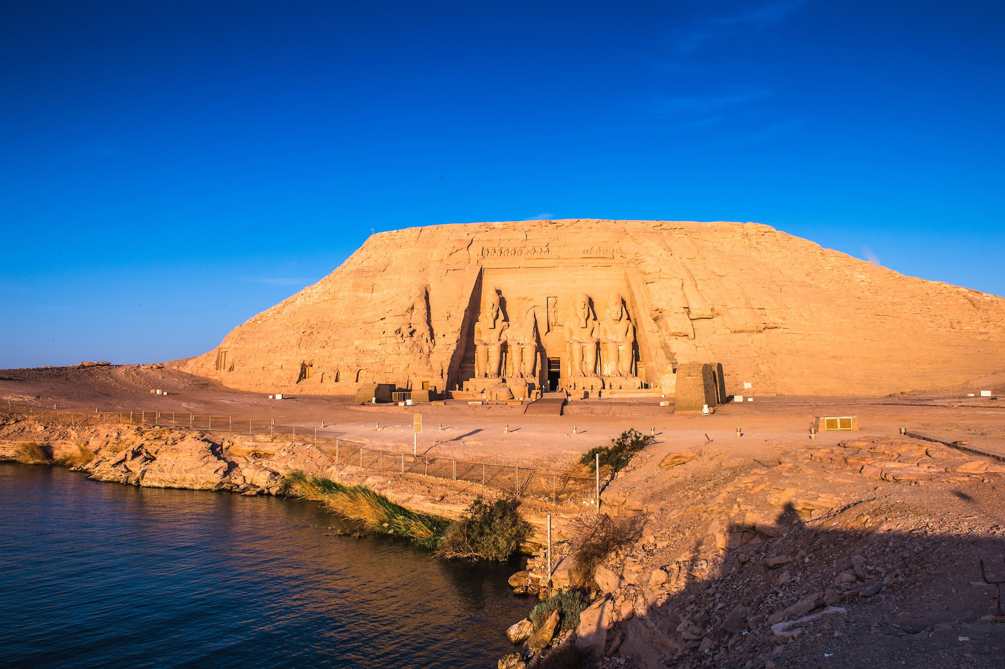Abu Simbel temples with colossal pharaoh statues beside Lake Nasser in Egypt