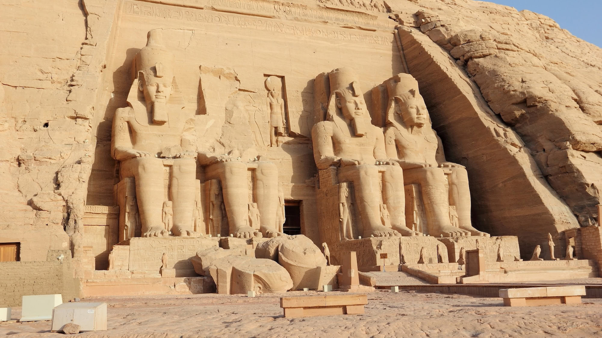 Four massive seated statues of Pharaoh Ramesses II carved into the Abu Simbel temple facade