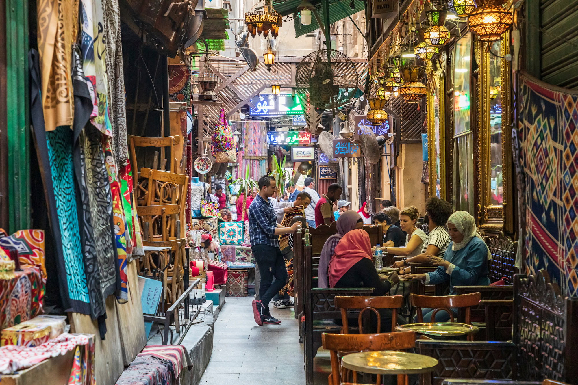 Traditional Middle Eastern bazaar with lanterns, textiles and narrow alleyways