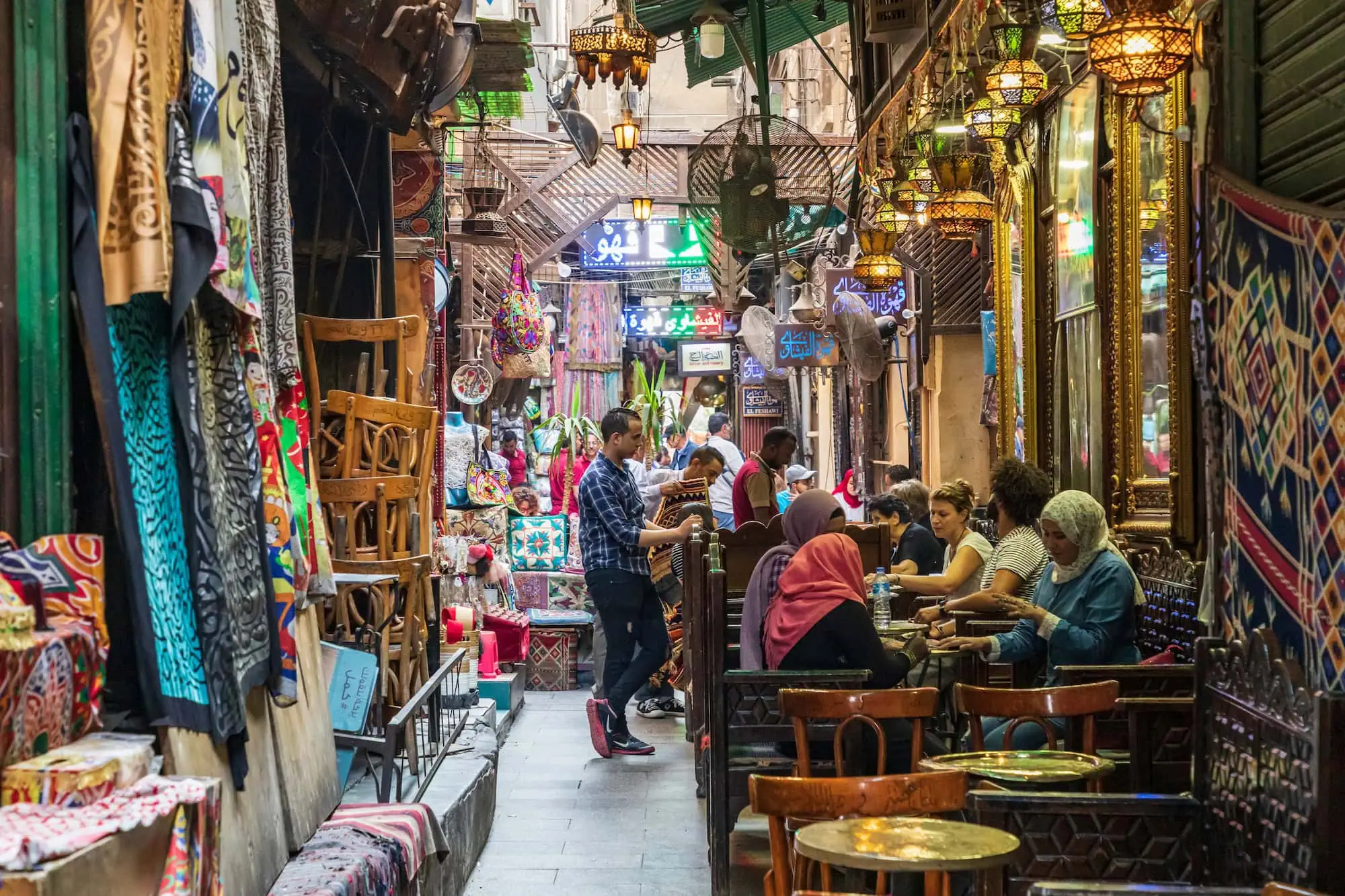 Traditional Middle Eastern bazaar with lanterns, textiles and narrow alleyways