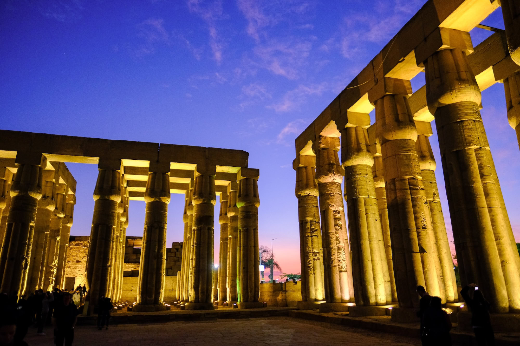 Luxor Temple columns and ancient architecture illuminated with evening lighting