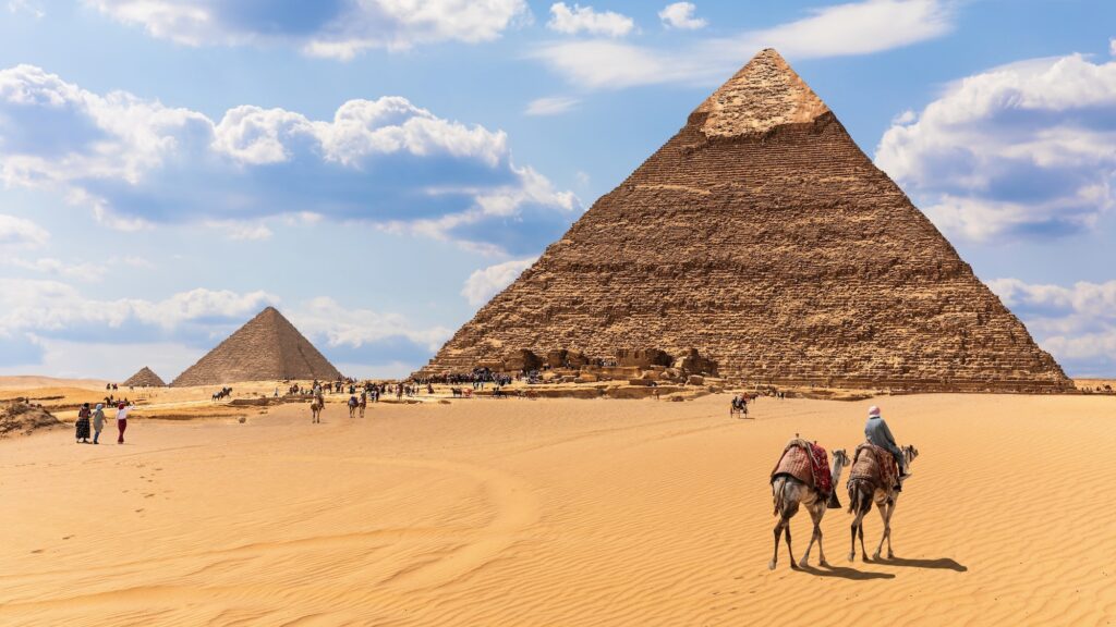 The Pyramids And Bedouins In The Desert Of Giza Egypt