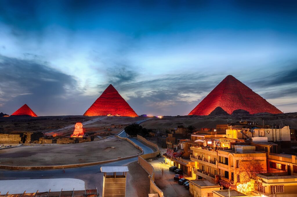 The Great Pyramids illuminated at night as seen from surrounding buildings, Giza