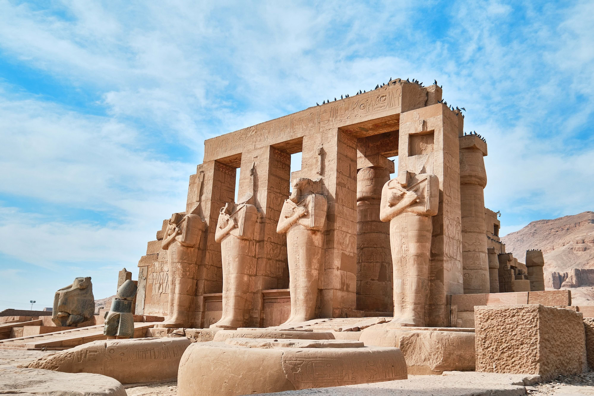 Ancient Ramesseum Temple ruins in Luxor showing massive columns, hieroglyphics, and pharaoh statues