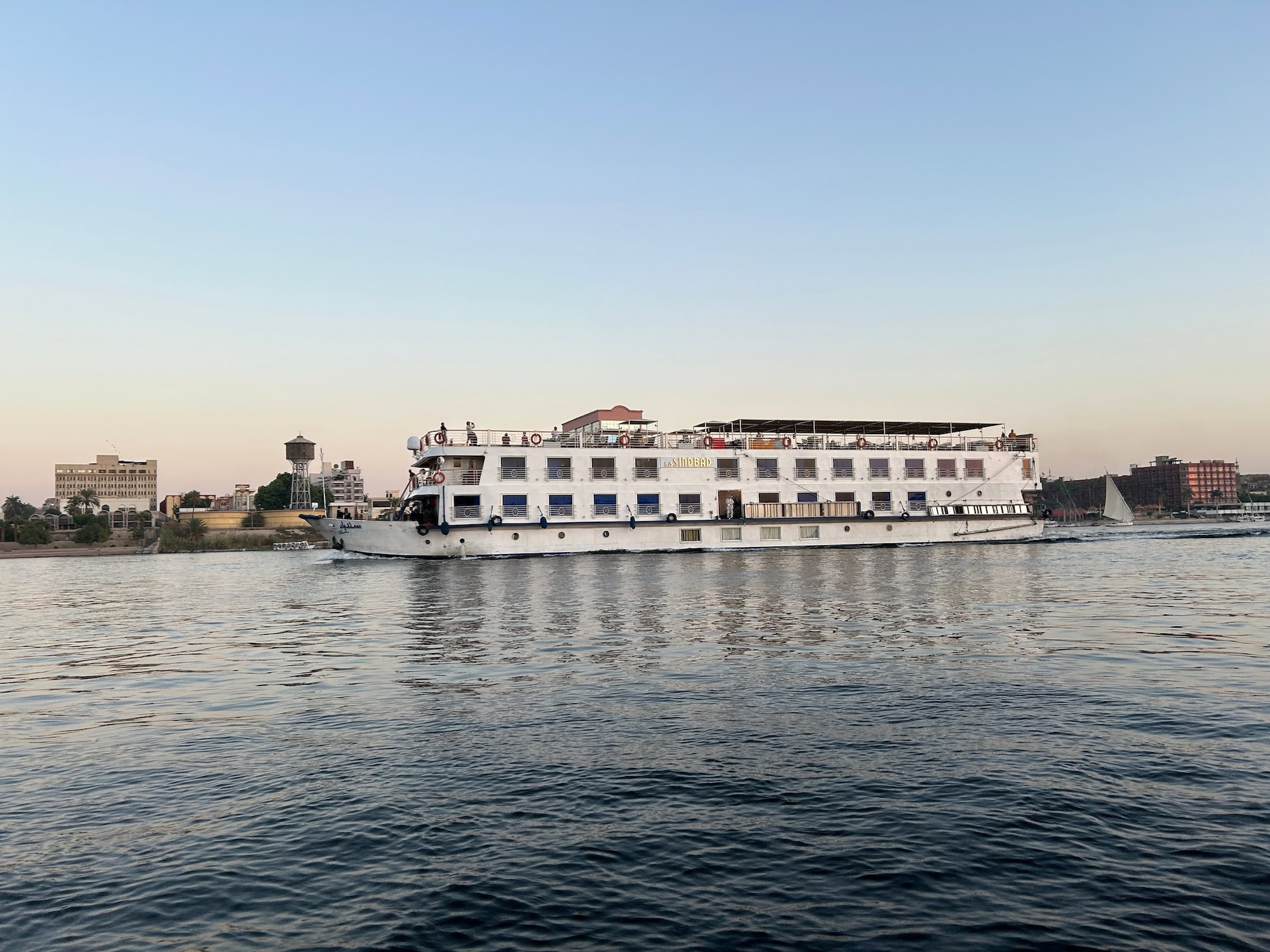White Nile cruise ship sailing on the Nile River at sunset in Luxor