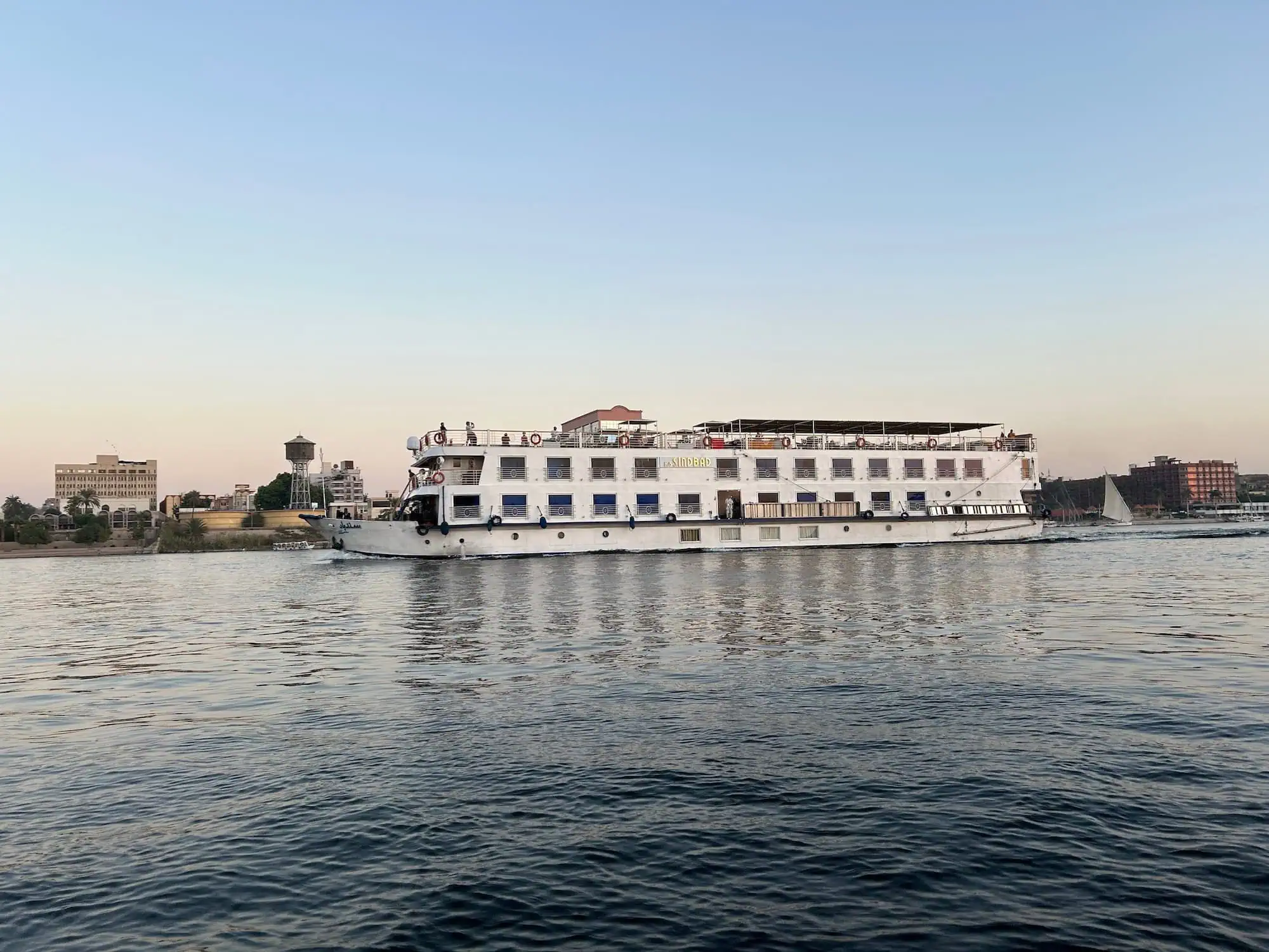 White Nile cruise ship sailing on the Nile River at sunset in Luxor