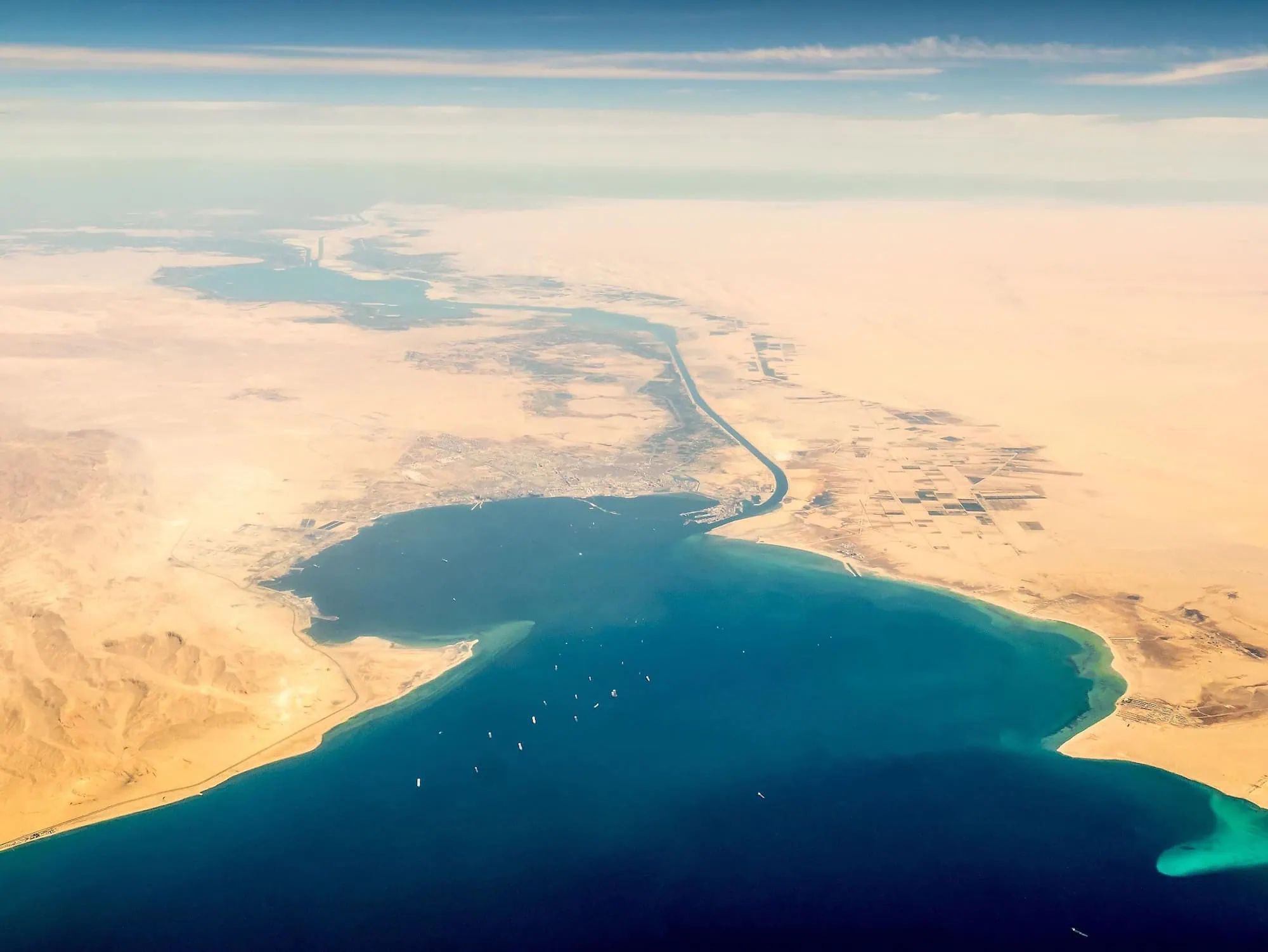 Aerial view of the Suez Canal waterway cutting through Egyptian desert landscape