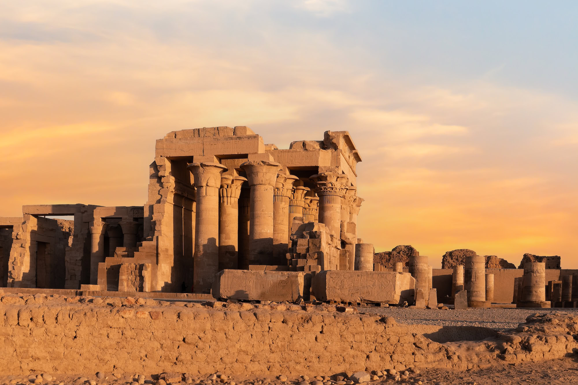 Majestic view of Kom Ombo Temple complex with ancient columns and ruins under dramatic sky