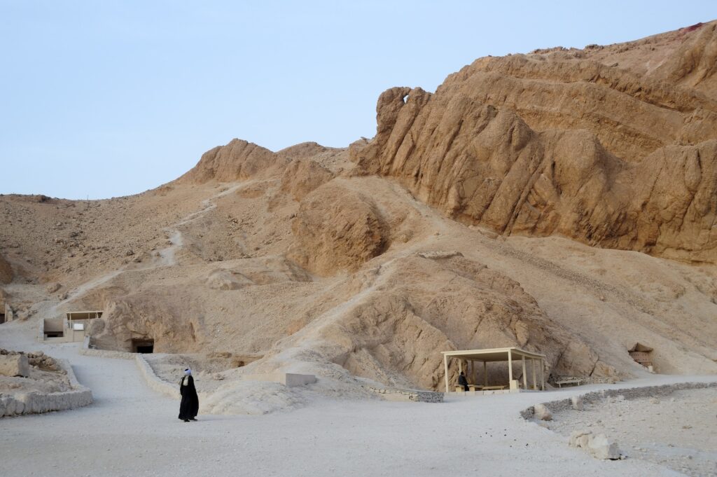 Desert valley with multiple rock-cut tomb entrances at the Valley of the Queens on the West Bank, Luxor