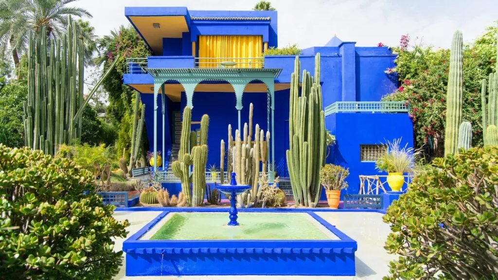 Majorelle Garden's iconic blue building with fountain and tropical plants