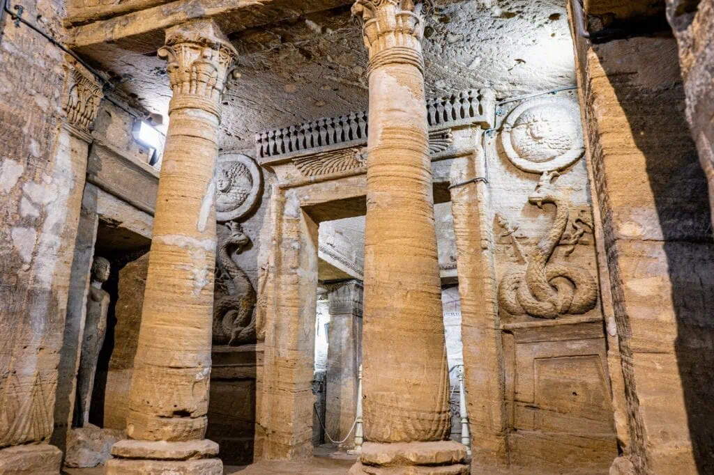 Interior view of rock-cut chambers and carved stone details inside the Catacombs of Kom El Shoqafa, Alexandria