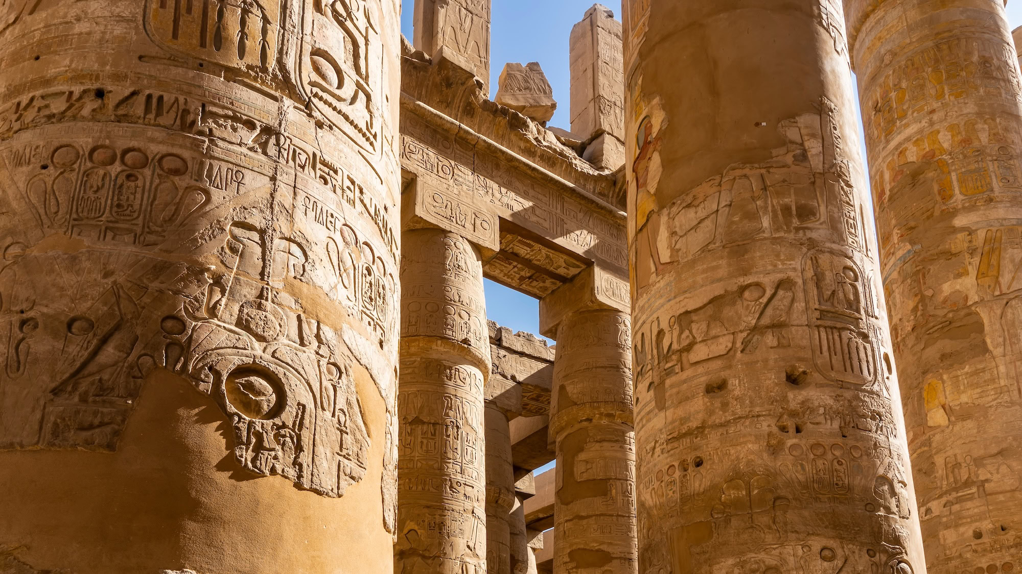 Massive sandstone columns with hieroglyphs at Karnak Temple Complex in Luxor