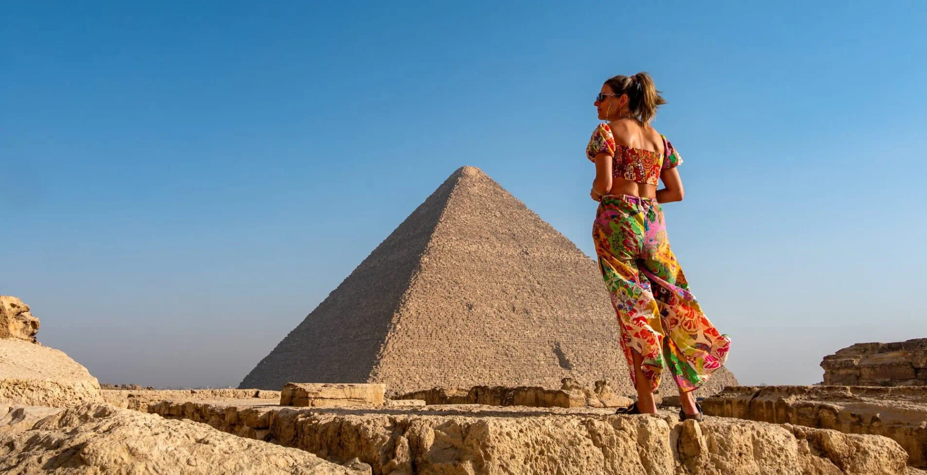 The pyramids of Giza in Egypt with a girl in front 1905x976 crop 46 64