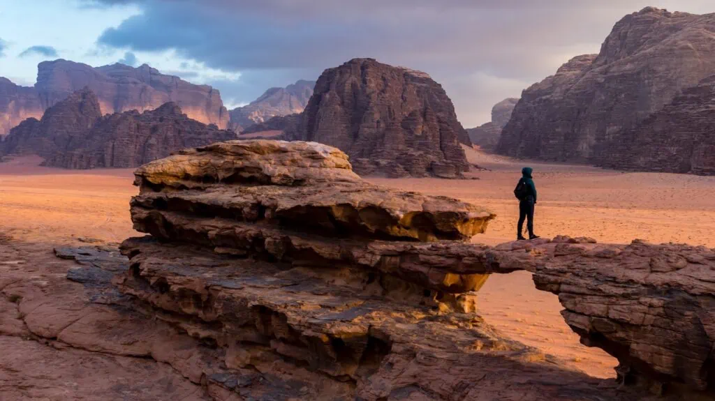 Red sandstone desert landscape with rock formations and open sand plains in Wadi Rum, Wadi Rum